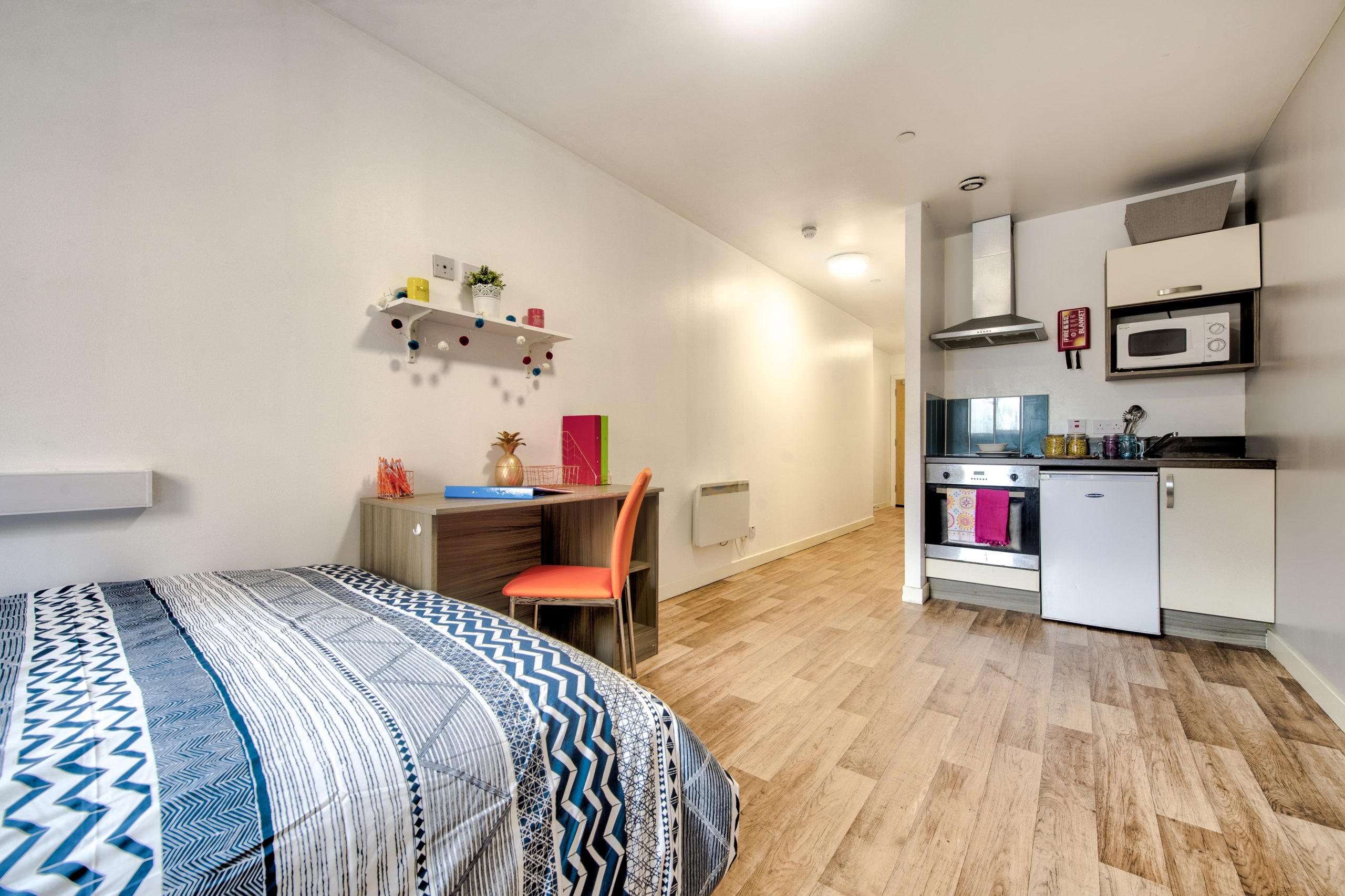 kitchen and double bed in studio apartment
